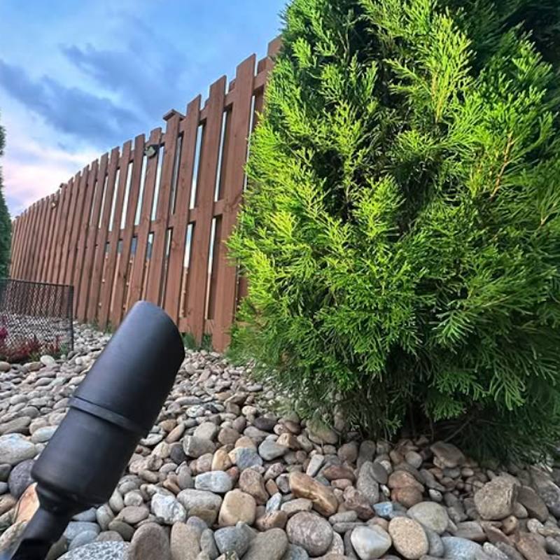 Low-voltage landscape light beside decorative stone